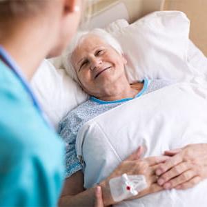 Hospital patient smiling with nurse